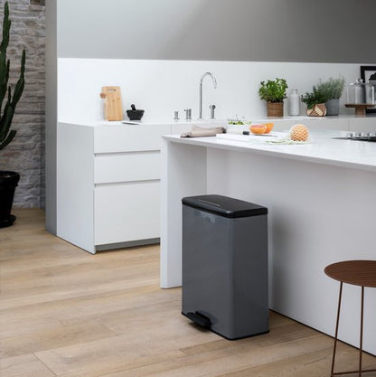 Curver Decobin 65L rectangular trash can with black lid and grey body in modern kitchen
