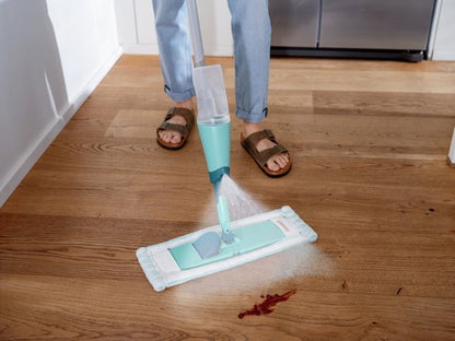 Leifheit Easy Spray XL floor mop with spray mechanism in turquoise and white on wooden floor