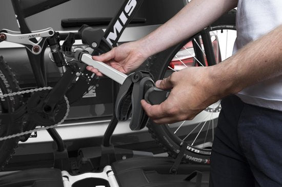 Thule EasyFold XT933 bike carrier being installed on vehicle hitch