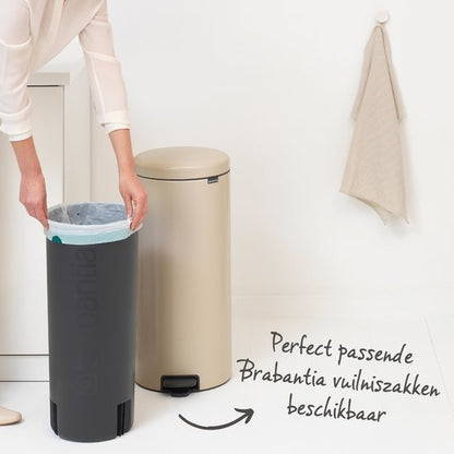 Brabantia NewIcon 30-liter cream pedal trash bin with black base and liner bag