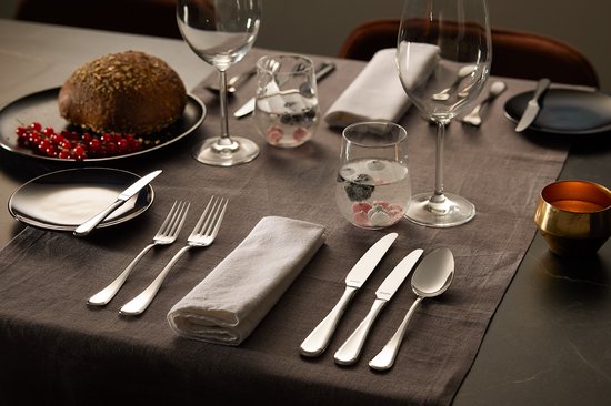 Amefa Drift flatware set with plated utensils on formal grey table setting