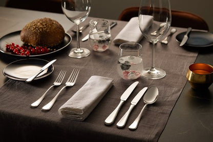 Amefa Drift flatware set with plated utensils on formal grey table setting