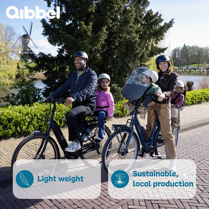 Qibbel Junior black rear bike child seat with two children and adults on bicycle near windmill