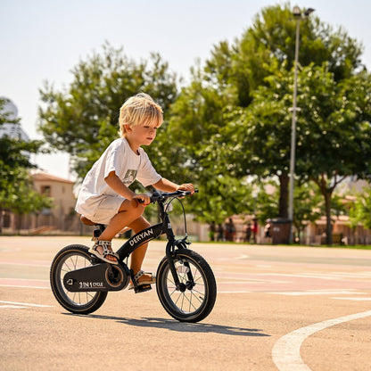 Young boy riding black Deryan children's bike with 12-inch wheels on outdoor court